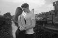 Close-up of young romantic couple is kissing and enjoying the company of each other in black and white. Young couple in love