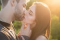 Close-up of young romantic couple is kissing. Profile of beautiful people in love expressing and affection while kiss Royalty Free Stock Photo