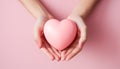 Close-up of a young romantic woman holding a pink heart. Concept of love, relationship and Valentine\'s Day Royalty Free Stock Photo