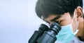 Close up young scientist looking at microscope Royalty Free Stock Photo