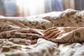 Close up young sick male hand lying in bed while strugle with ilness f Royalty Free Stock Photo