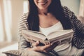 Close up. Young Smiling Woman Reading Book at Home Royalty Free Stock Photo