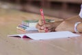 Close up of young student hands writing on notebook