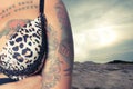 Close up of Young tattooed woman at the beach