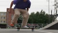 Close up young teenager skater skateboarder man doing 360 kickflip heelflip flip trick jump, ollie, on skateboard in