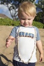 Two year old boy on a beach with a shell necklace Royalty Free Stock Photo