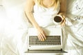 Big spacey hotel room full of sunlight and sun beams. Optimistic start of the day. Blond woman cozy home clothing welcoming the mo Royalty Free Stock Photo