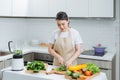 Close up of young woman with blender and green vegetables making detox shake or smoothie at home Royalty Free Stock Photo