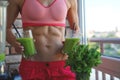 Close up of young woman with blender and green vegetables making detox shake or smoothie at home Royalty Free Stock Photo