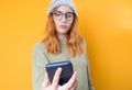 Close-up young woman browse on mobile phone, isolated on yellow background. Close up female holding smart phone. Focus on phone