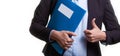 Close up of a young woman in a business suit holding a file. Copy space