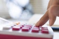 Close up young woman with calculator counting