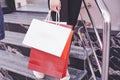 Close up young woman carrying shopping bags while walking on the stairs after visiting the stores Royalty Free Stock Photo