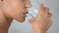 Close up of young woman drink clean water in bath Royalty Free Stock Photo