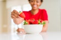 Close up of young woman eating fresh strawberries Royalty Free Stock Photo