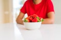 Close up of young woman eating fresh strawberries Royalty Free Stock Photo