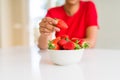 Close up of young woman eating fresh strawberries Royalty Free Stock Photo