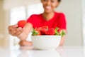 Close up of young woman eating fresh strawberries Royalty Free Stock Photo