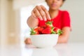 Close up of young woman eating fresh strawberries Royalty Free Stock Photo