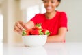 Close up of young woman eating fresh strawberries Royalty Free Stock Photo