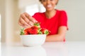 Close up of young woman eating fresh strawberries Royalty Free Stock Photo