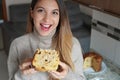 Close-up of young woman eating a slice of Panettone traditional Italian cake for Christmas with raisins and candied fruits Royalty Free Stock Photo