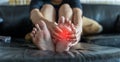 Close-up of young woman feeling pain in feet at home. Health care and medical concept. Royalty Free Stock Photo