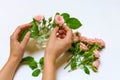 Close up of young woman florist hand creating bouquet of pink roses on a light Royalty Free Stock Photo