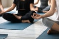 Close up young woman folded fingers in mudra gesture.