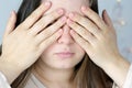 Close-up of a young woman, a girl with long hair, covering her face with her hands, the concept of awakening, hiding, not looking Royalty Free Stock Photo