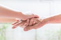 Close up of young woman hand holding with tenderness an elderly Royalty Free Stock Photo