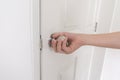 Close-up young woman handle stainless door knob, Women are opening door,Close up door knob. Royalty Free Stock Photo