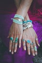 Close up of young woman hands with boho accessories rings and br