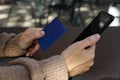 Close up young woman hands holding smartphone and credit card Royalty Free Stock Photo