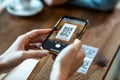 Young woman hands using the smart phone to scan the qr code to select food menu in the restaurant Royalty Free Stock Photo