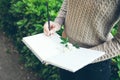 Close-up of young woman hands writing down her hopes and dreams of future into her diary, making plans. Royalty Free Stock Photo