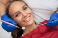 Dentist examining a patient`s teeth with dental tools - mirror and probe. Dentistry. Macro shot Royalty Free Stock Photo