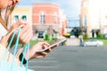 Close up of a young woman hold a shopping bags in her hand and chatting on her phone after shopping. Royalty Free Stock Photo