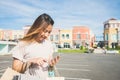 Close up of a young woman hold a shopping bags in her hand and chatting on her phone after shopping. Royalty Free Stock Photo