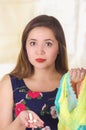 Close up of a young woman, holding an assorted colorful underwears and a soft gelatin vaginal tablet or suppository