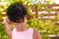 Close up of young woman holding back of neck in pain, outdoor yoga in garden Royalty Free Stock Photo