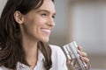 Closeup young woman holding glass with clean, pure, mineral water