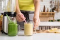 Close up of a young woman holding a jar of fruit smoothie Royalty Free Stock Photo