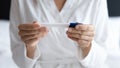 Close up young woman holding pregnancy test, checking result Royalty Free Stock Photo