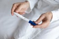 Close up young woman holding pregnancy test in hands Royalty Free Stock Photo