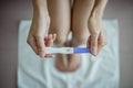 Close-up of young woman holds a pregnancy test in her hands. Positive pregnancy test Royalty Free Stock Photo