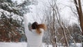 Close up, Young woman jumping on the snow covered road, having fun in the park on the winter Royalty Free Stock Photo