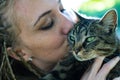 Close up on young woman kissing adorable cat Royalty Free Stock Photo