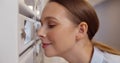 Close up of young woman looking through gap in mailbox at apartment lobby Royalty Free Stock Photo