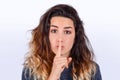 Close up of young woman making silence gesture Royalty Free Stock Photo